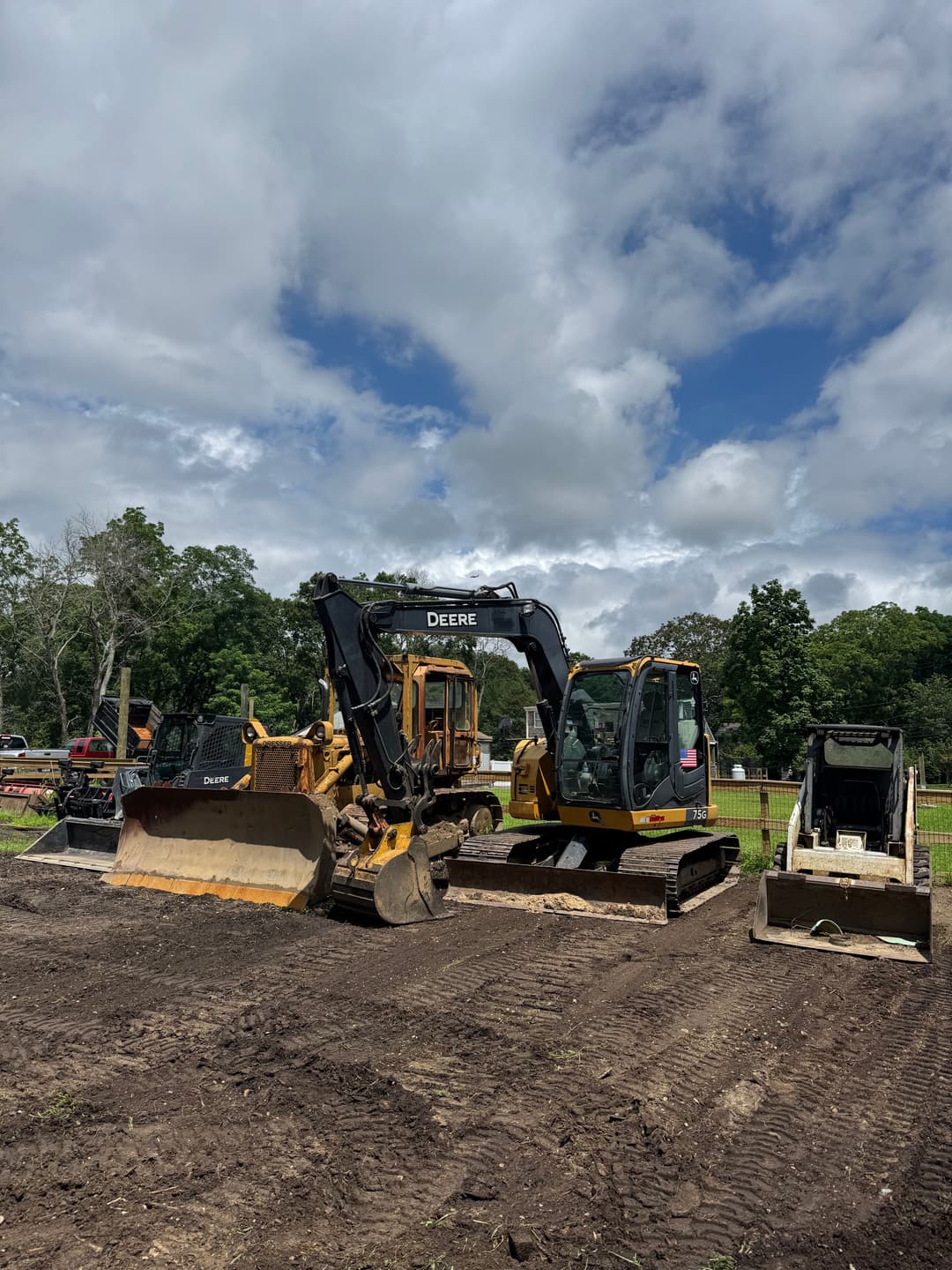Construction site featuring various heavy machinery, including excavators and bulldozers.